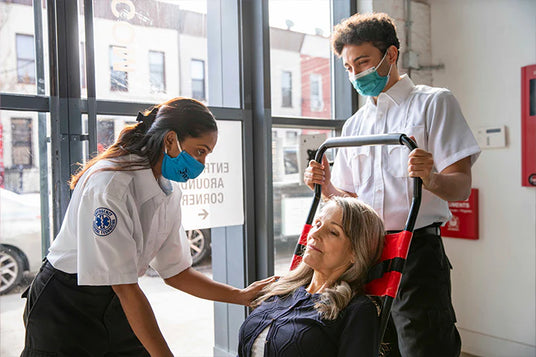 EMS worker evacuating a woman