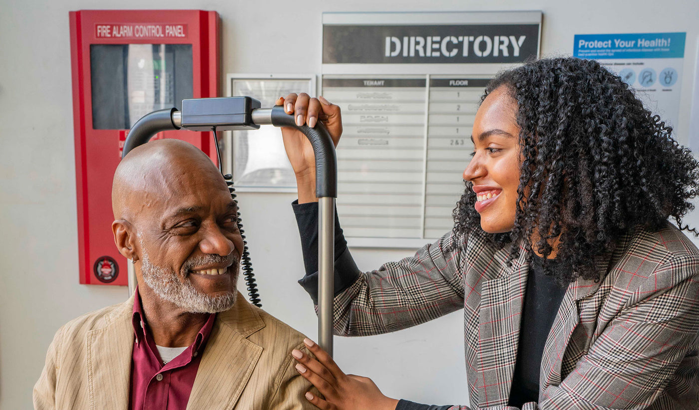 Father helping daughter onto stairlift