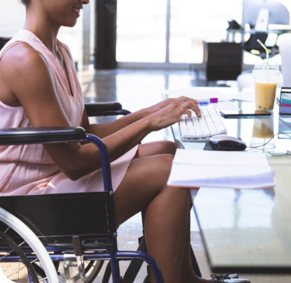 Young disabled businesswoman working on a computer.