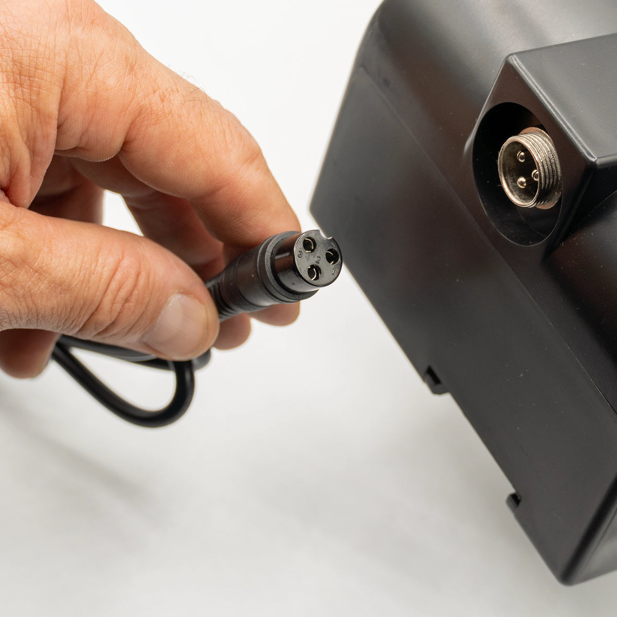 Rear label view of the Mobile Stairlift Helix battery charger showing the power cord and DC output connector