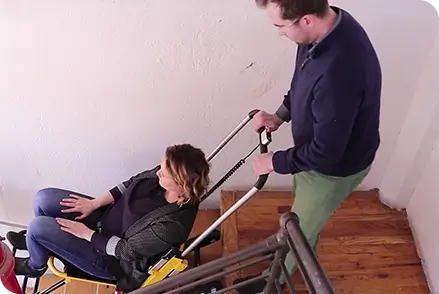 Person descending stairs with stairlift