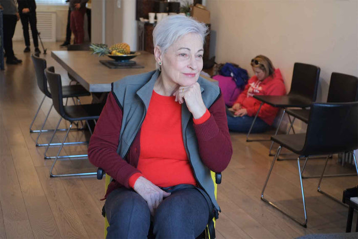 Senior woman seated, highlighting mobility and comfort.